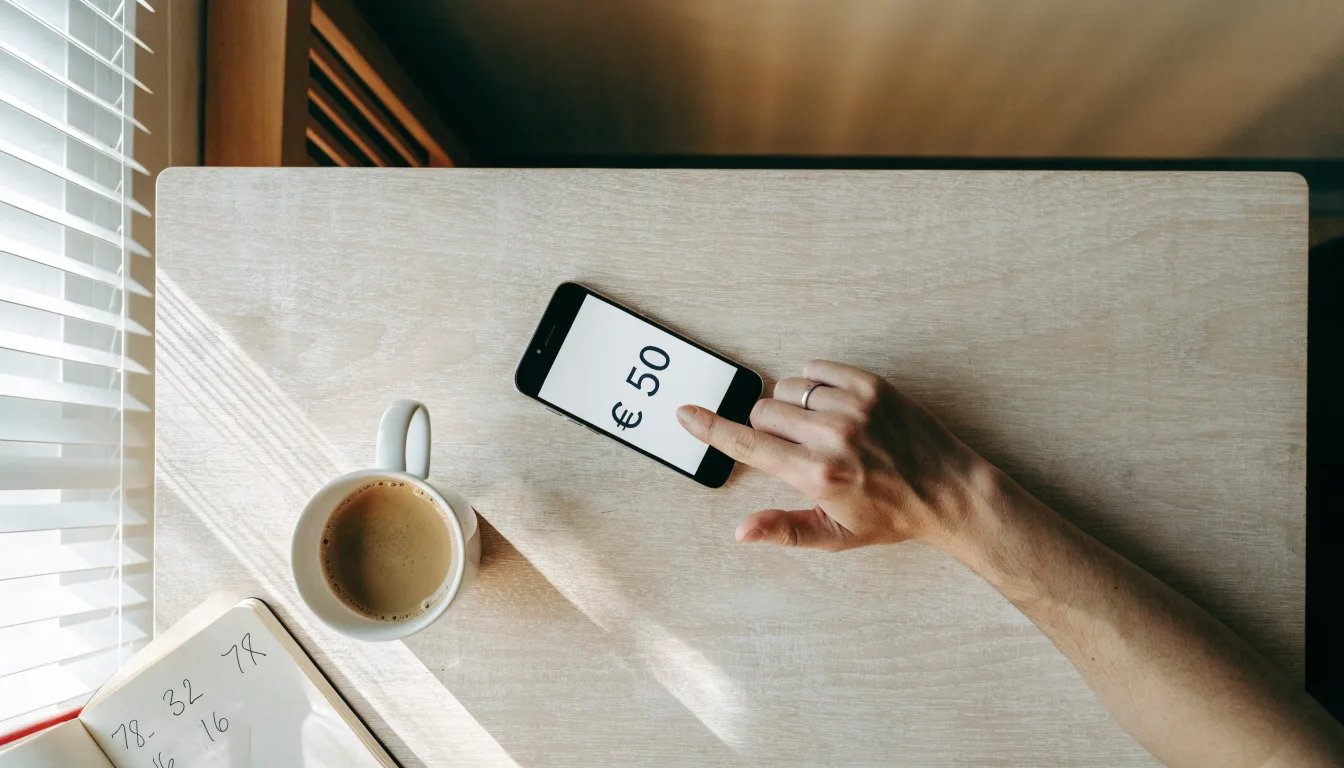 Un documento di identità appoggiato accanto a uno smartphone con un timer sullo schermo, su un tavolo da cucina